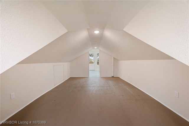 additional living space featuring lofted ceiling