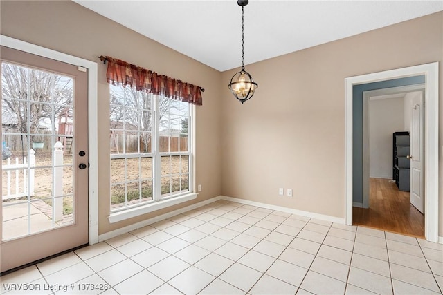 unfurnished dining area featuring light tile patterned floors