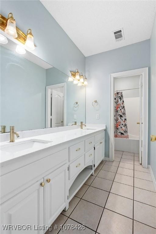 bathroom featuring vanity, tile patterned flooring, and shower / tub combo with curtain