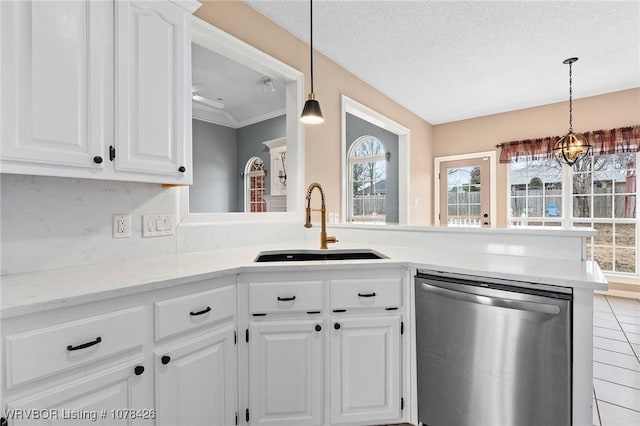 kitchen featuring dishwasher, sink, an inviting chandelier, white cabinetry, and a textured ceiling