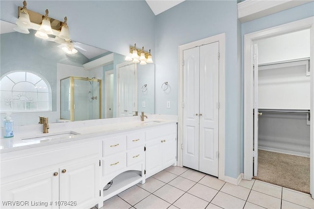 bathroom with tile patterned flooring, vanity, walk in shower, vaulted ceiling, and ceiling fan