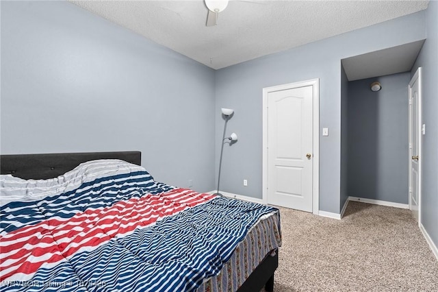 bedroom featuring a textured ceiling, ceiling fan, and carpet flooring