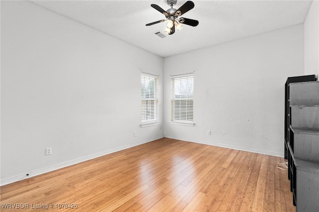 spare room with ceiling fan and light hardwood / wood-style flooring