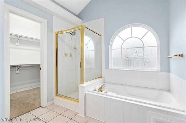 bathroom with lofted ceiling, shower with separate bathtub, and tile patterned floors