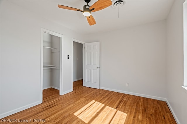 unfurnished bedroom featuring a closet, baseboards, ceiling fan, and light wood finished floors