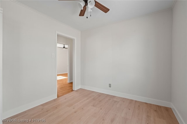 empty room featuring baseboards, wood finished floors, a ceiling fan, and crown molding