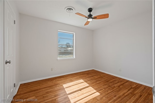 unfurnished bedroom with a ceiling fan, wood finished floors, visible vents, and baseboards