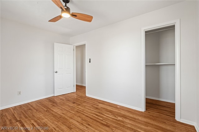 unfurnished bedroom with a ceiling fan, a closet, baseboards, and wood finished floors