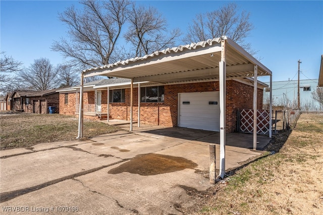 view of front of property with driveway, brick siding, an attached garage, and an attached carport