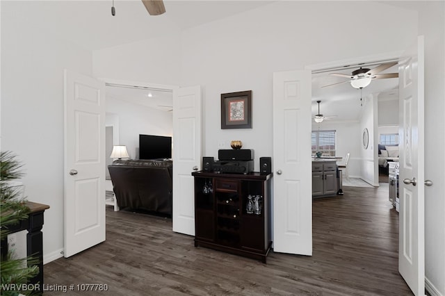 corridor with dark hardwood / wood-style flooring and vaulted ceiling