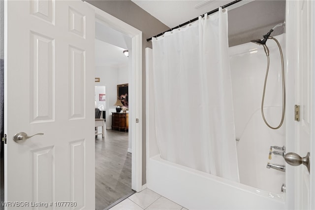 bathroom with tile patterned flooring and shower / tub combo with curtain