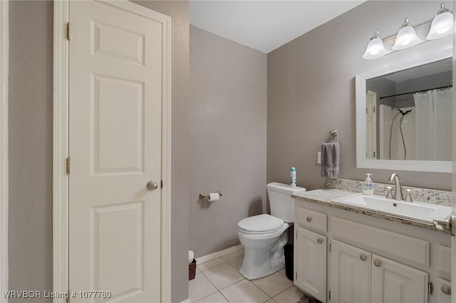 bathroom with tile patterned floors, curtained shower, vanity, and toilet