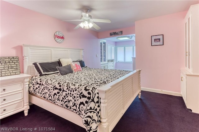 bedroom with ceiling fan and dark colored carpet