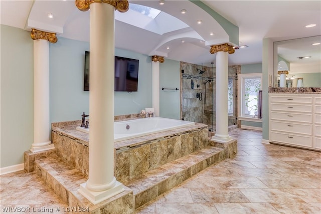 bathroom with vanity, separate shower and tub, and decorative columns