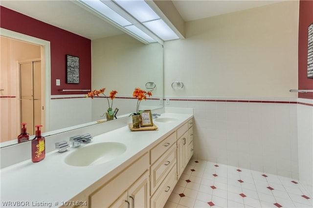 bathroom with tile patterned floors, vanity, and tile walls