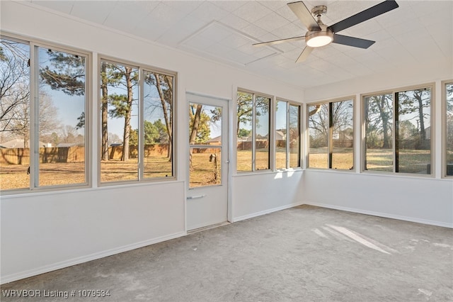 unfurnished sunroom featuring ceiling fan