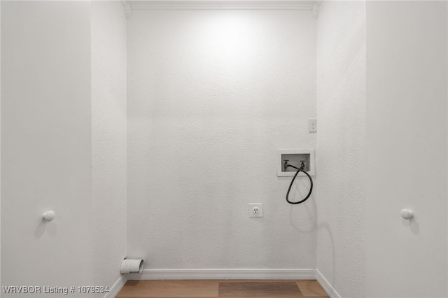 laundry room featuring light wood finished floors, baseboards, hookup for an electric dryer, hookup for a washing machine, and laundry area