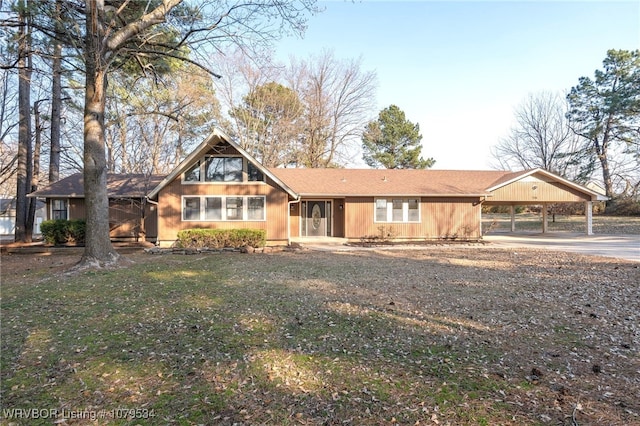 view of front of property with concrete driveway and a carport