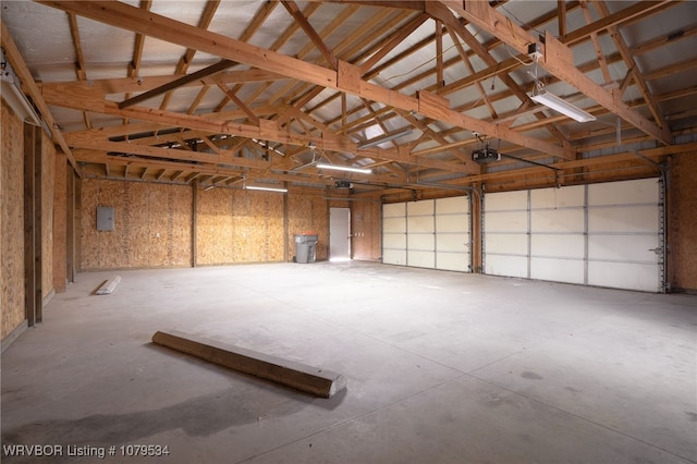 garage featuring electric panel and a garage door opener