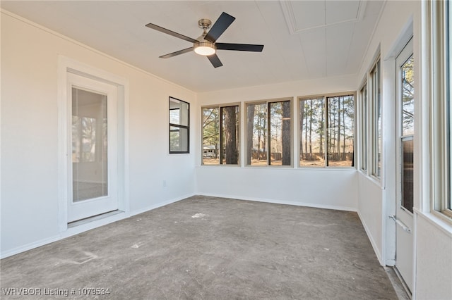 unfurnished sunroom with ceiling fan