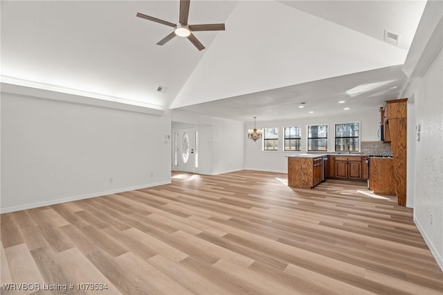 unfurnished living room with visible vents, ceiling fan with notable chandelier, and light wood-type flooring