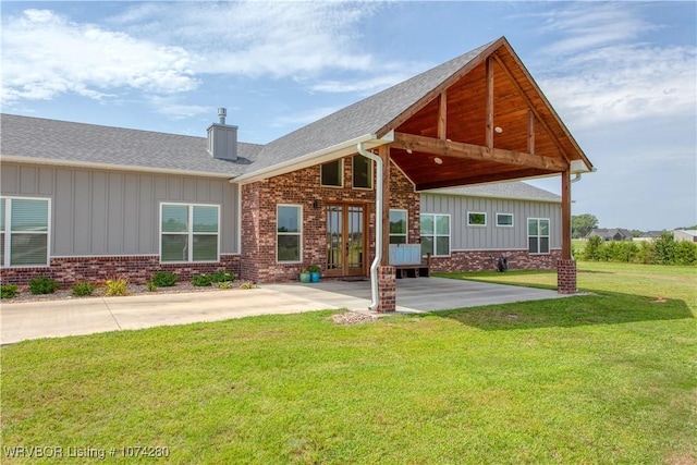 back of property featuring french doors and a yard