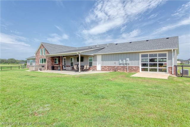 back of house with cooling unit, a yard, and a patio