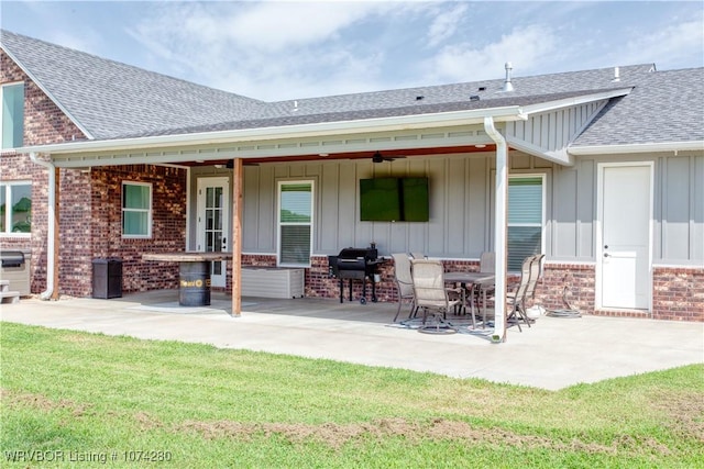 rear view of property with a yard and a patio