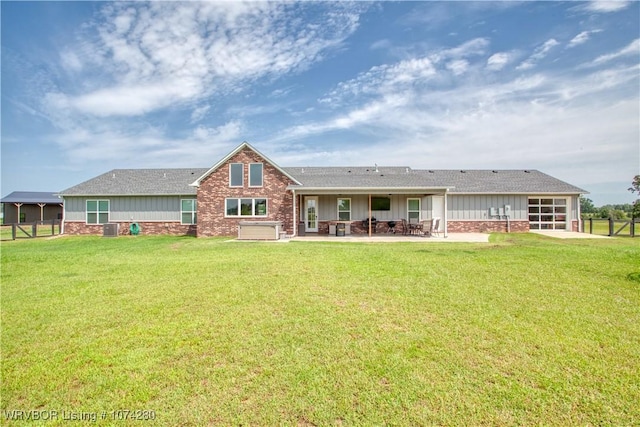 back of property featuring a yard, a patio, and central air condition unit