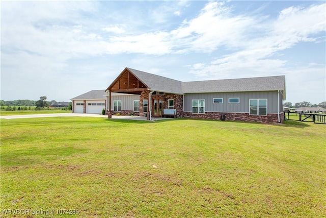 view of front of property with a garage and a front yard