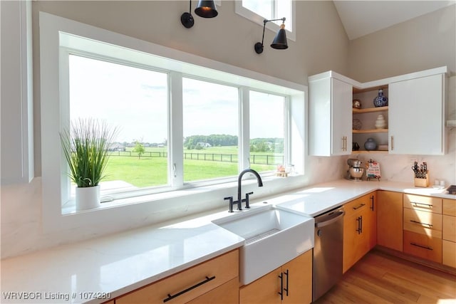 kitchen with white cabinetry, stainless steel dishwasher, plenty of natural light, and sink