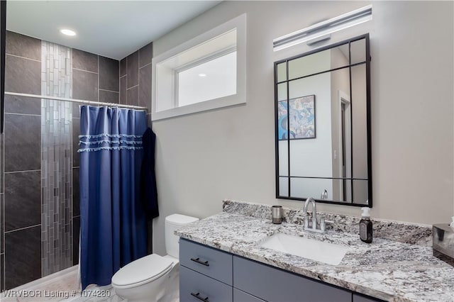 bathroom with vanity, toilet, and walk in shower