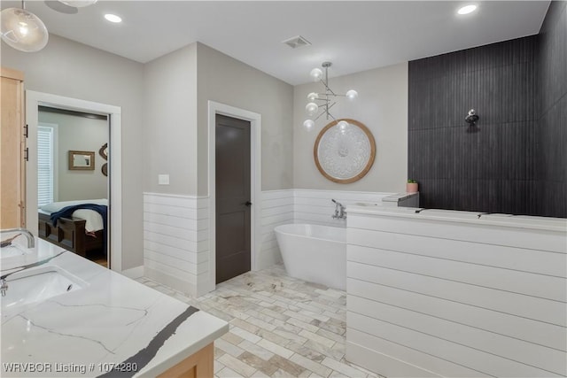 bathroom with vanity, tile walls, and shower with separate bathtub