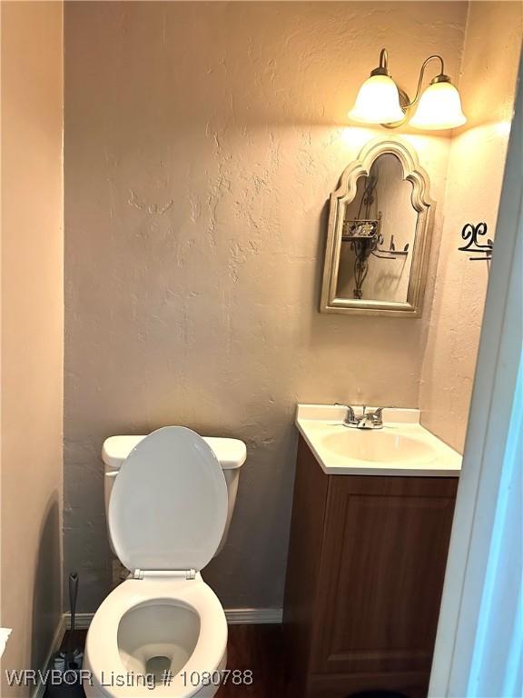 bathroom with toilet and vanity