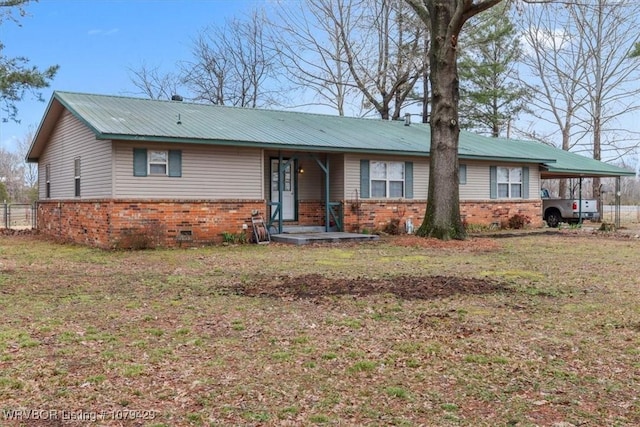 ranch-style home featuring crawl space, brick siding, metal roof, and a front lawn