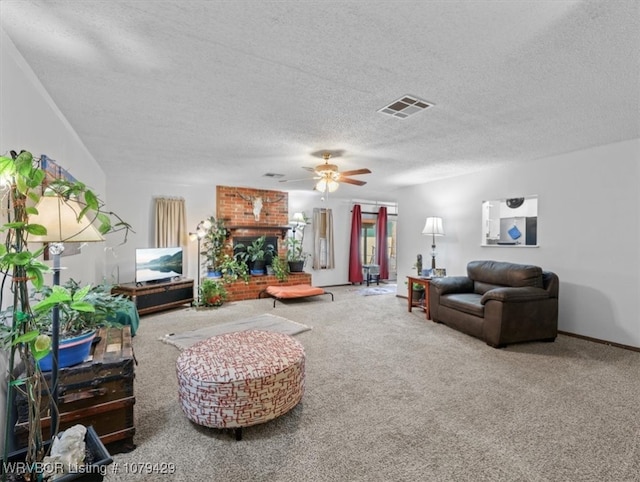 living area with a brick fireplace, carpet, visible vents, and ceiling fan