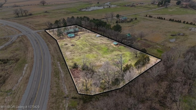 birds eye view of property with a rural view