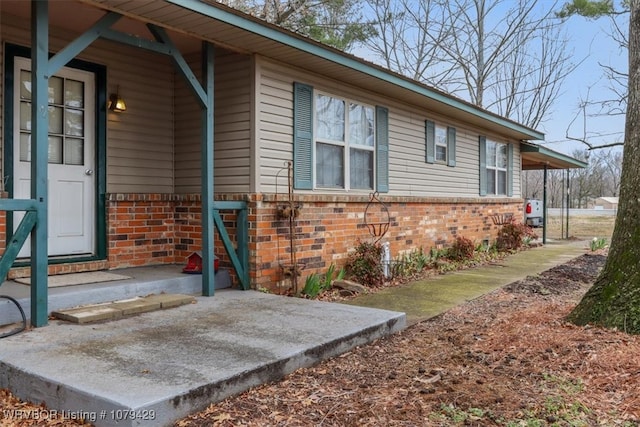 exterior space with brick siding