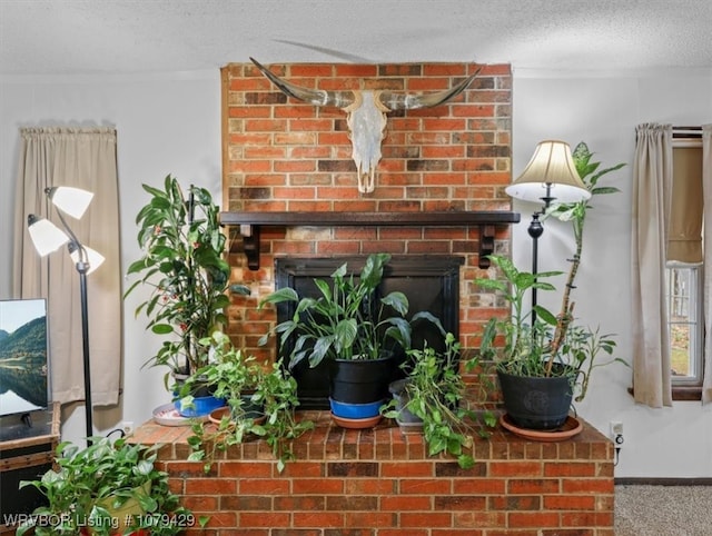 interior details featuring baseboards, a brick fireplace, a textured ceiling, and carpet