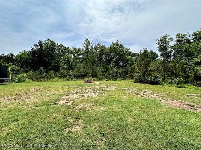 309 Arcadia Dr, Poteau, OK 74953 - view of green lawn featuring a trampoline