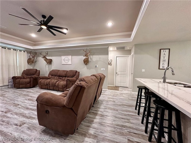 309 Arcadia Dr, Poteau, OK 74953 - living room with a raised ceiling, ornamental molding, light wood-style flooring, ceiling fan, and baseboards