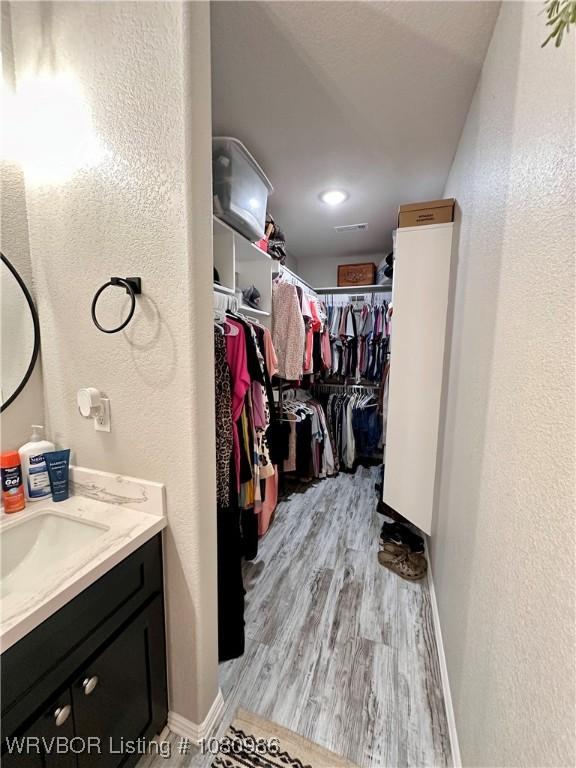 309 Arcadia Dr, Poteau, OK 74953 - spacious closet featuring light wood-style flooring and a sink