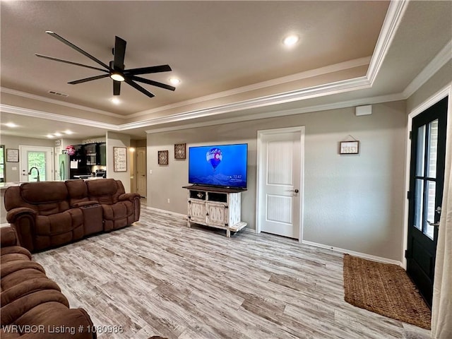 309 Arcadia Dr, Poteau, OK 74953 - living area with a tray ceiling, wood finished floors, healthy amount of natural light, crown molding, and baseboards