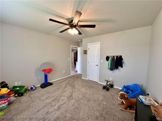309 Arcadia Dr, Poteau, OK 74953 - unfurnished bedroom featuring a textured ceiling, carpet flooring, a ceiling fan, and baseboards
