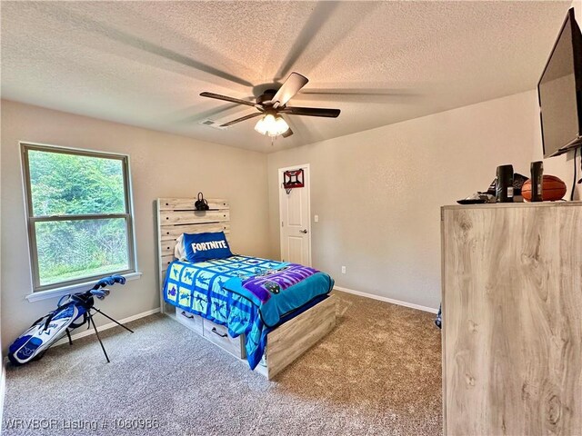 309 Arcadia Dr, Poteau, OK 74953 - bedroom featuring carpet flooring, a textured ceiling, baseboards, and ceiling fan