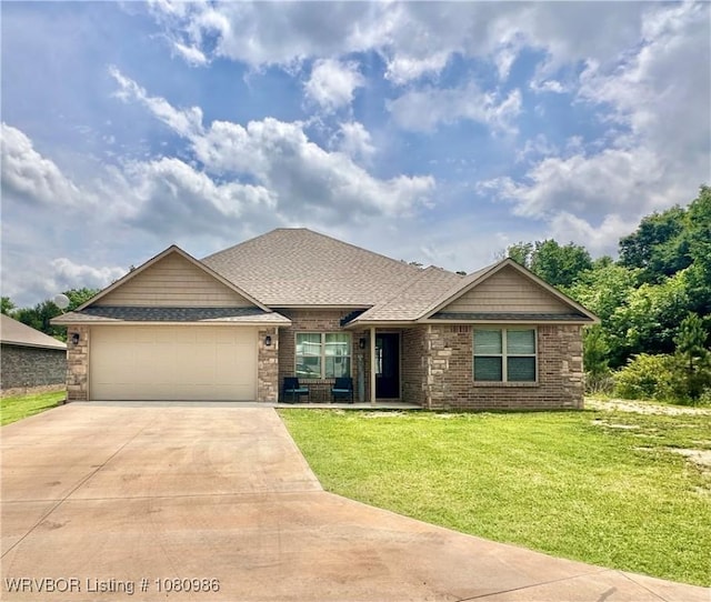 309 Arcadia Dr, Poteau, OK 74953 - view of front facade featuring concrete driveway, an attached garage, a front lawn, roof with shingles, and brick siding