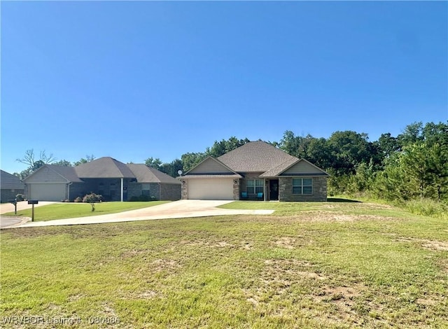 309 Arcadia Dr, Poteau, OK 74953 - view of front of property featuring concrete driveway, a garage, a front lawn, and stone siding