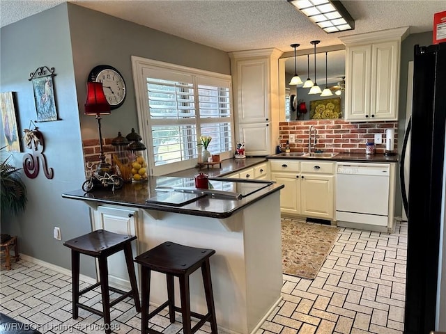 7434 N 217th Hwy, Charleston, AR 72933 - kitchen featuring black appliances, dark countertops, brick patterned flooring, a peninsula, and a textured ceiling