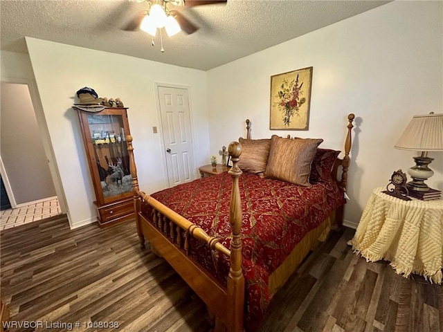 7434 N 217th Hwy, Charleston, AR 72933 - bedroom with wood finished floors, a textured ceiling, and a ceiling fan
