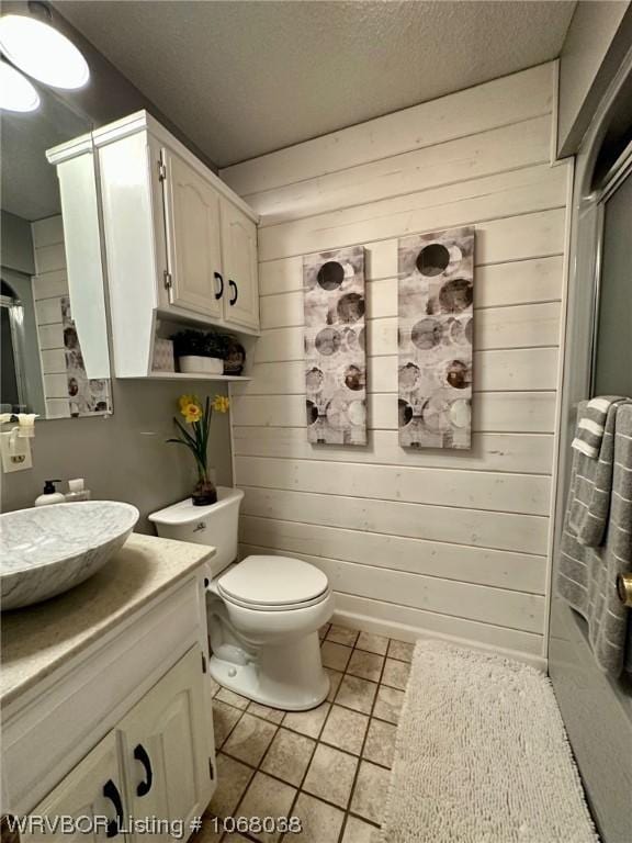 7434 N 217th Hwy, Charleston, AR 72933 - bathroom featuring vanity, wooden walls, tile patterned floors, and a textured ceiling